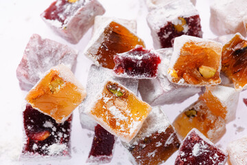 Sweet food Turkish delight, assorted rahat locum in form of cubes with nuts and powdered sugar, traditional food, on white background
