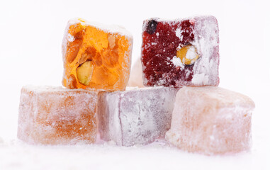 Sweet food Turkish delight, assorted rahat locum in form of cubes with nuts and powdered sugar, traditional food, on white background