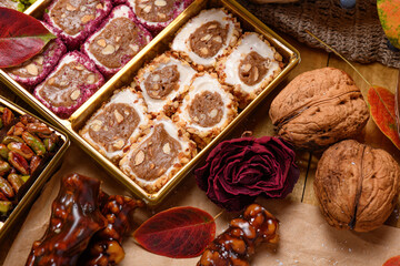 Sweet food Turkish delight on wooden background, assorted locum and candy as decorated backdrop