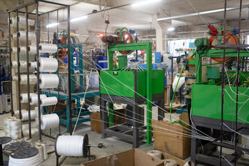 Industrial textile manufacturing facility with yarn machine in operation