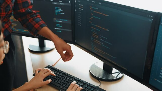 Slow motion back end or software developer manager supervising his team on new application program development on debugging and solving complex code algorithms on monitor. Burgeoning