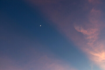 Serene twilight sky with soft cloud formations.