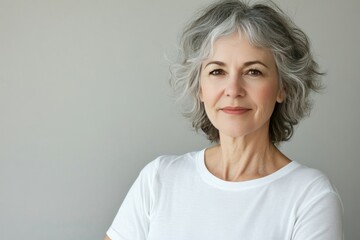 Fototapeta premium Thoughtful Older Woman with Gray Hair Smiling