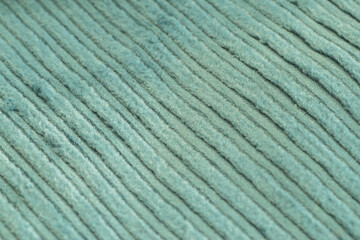 Turquoise textured corduroy fabric patterns closeup as textile background