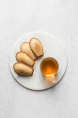 vanilla madeleines on a white marble tray, plain french vanilla madeleine cake or cookies