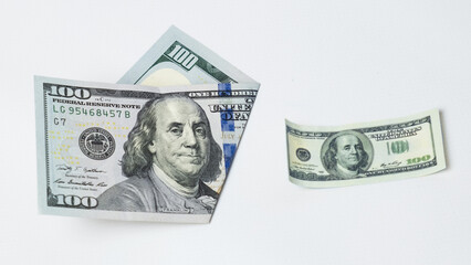 Two hundred dollar bills-a regular size and a small one. The concept of inflation, depreciation of money, loss of income.
