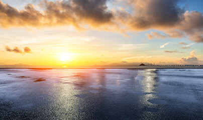 Asphalt road square and coastline with beautiful sky clouds nature landscape at sunrise. Outdoor asphalt parking lot.