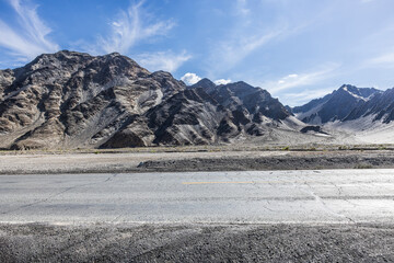 Asphalt road and mountain nature landscape under blue sky. Outdoor natural background.