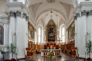 The interior of a church is very large and very white