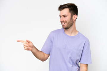 Young caucasian man isolated on white background pointing finger to the side and presenting a product