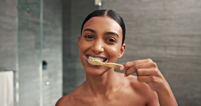 Brushing teeth, face and woman with smile for oral health, dental care and grooming. Bathroom pov, happy and girl with toothpaste for morning cleaning, gum hygiene and toothbrush whitening in mirror