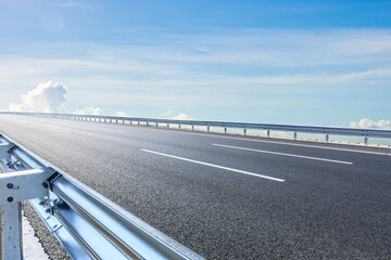 Asphalt road and sky clouds scenery under blue sky. Outdoor road background.