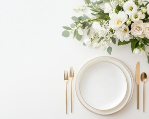 Table setting with gold cutlery and white floral arrangements