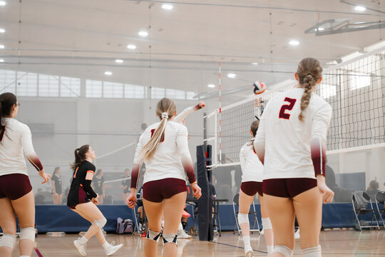College women playing volleyball