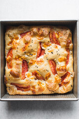 overhead view of homemade tomato focaccia, top view of focaccia with tomato and cheese topping, fresh homemade focaccia bread