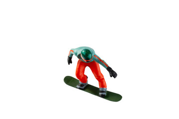 Miniature figurine depicting a snowboarder in mid-motion isolate on white background with clipping path