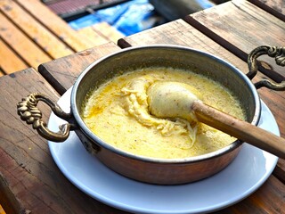 Kuymak or muhlama is a traditional dish from the Black Sea region of Türkiye made with melted cheese, butter, and cornmeal, cooked in an iron skillet or sahan