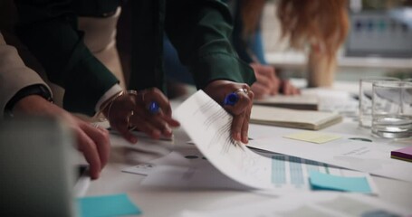 People, hands and paper in office for planning, campaign management and teamwork for productivity. Employees, documents and sticky notes in workplace for schedule, reminders and project information