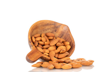 Fragrant roasted almonds in a wooden cup, close-up, isolated on a white background.