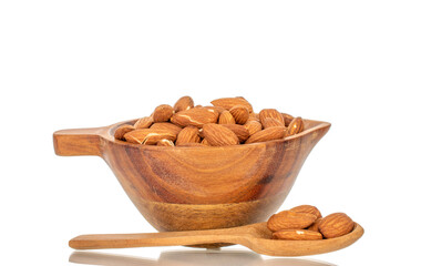 Fragrant roasted almonds in a wooden cup, close-up, isolated on a white background.