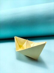 paper boat on blue background
