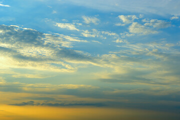 Real majestic sunrise sundown sky background with gentle colorful clouds without birds.