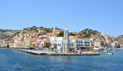 Fototapeta premium the port of a city is located on the coast of the greek island Symi