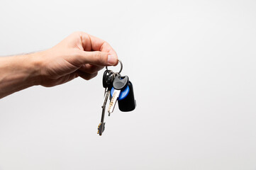 Salesman businessman holding keys, advertising sale, services or purchase of real estate. close-up...