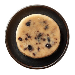 Top view of a delicious looking Spotted Dick on a dark dish isolated on a white transparent background