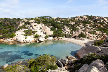 Caprera Island. Amazing crystal clear emerald sea touches rocky coast of Caprera island in...