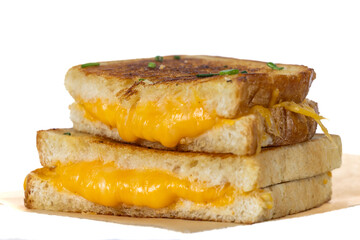 Grilled Cheese with melting cheese dripping from the inside. The sandwich is cut in half and ready to eat.
