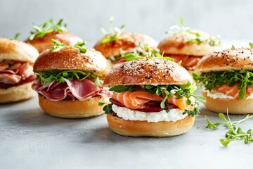 Variety of Bagel sandwiches with ricotta, prosciutto or chicken ham or salmon and microgreens.