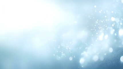 Abstract snowy night background with pale blue and white tones, scattered light specks and a glowing bokeh effect