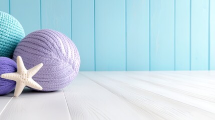 Three balls of yarn and a starfish on a white table