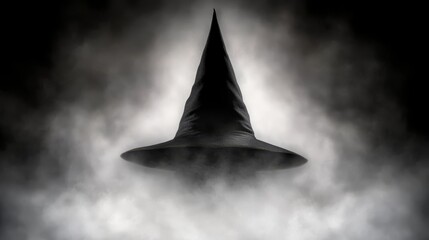A black and white photo of a witches hat in the clouds