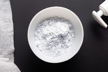 Bowl with alginate mask powder on black background