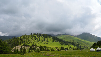 Mountains views of meadows and rivers on a summer cloudy day , Kazakhstan, Kegen, Aktas mount, Tekes river.