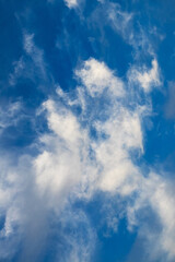 white variegated clouds of strange shape in the blue sky