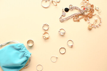 Stylish feminine golden and silver rings on beige background. Top view. flatlay