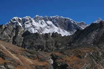 Amazing views on trekking to Kongma La Pass 5535 m with Lhotse Mount, Nuptse massif and silhouette of trekking person, from Dingboche to Lobuche. Everest Base Camp trek. Himalayas, Nepal