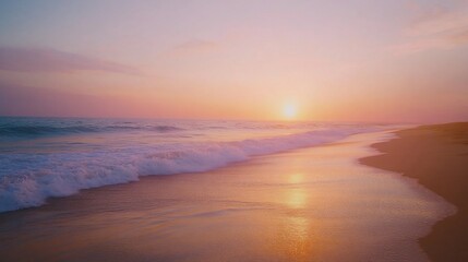 Fototapeta premium Soft pastel sunset over ocean waves on sandy beach.