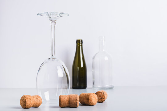 Alcohol abstinence, upside down wine glass among corks on table - Powered by Adobe