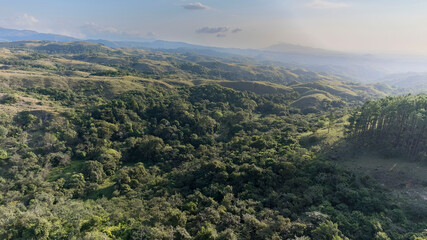 Fototapeta premium Aerial view of the central mountain corridor of Panama, with a slight fog and the sun shining.