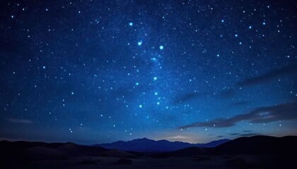 Naklejka premium Starry Night Sky Over Silhouetted Mountains