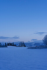 The blue hour in the cultural landscape of Toten, Norway, in December.