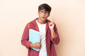 Young student caucasian man isolated on ocher background intending to realizes the solution while...