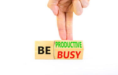 Be productive not busy symbol. Concept words Be productive Be busy on wooden block. Beautiful white table white background. Businessman hand. Business be productive not busy concept. Copy space.