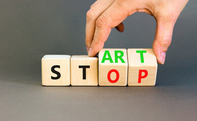 Start or stop symbol. Concept words Start or Stop on beautiful wooden block. Beautiful grey table...