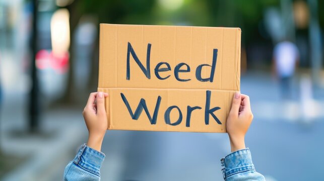 Person Seeking Employment with 'Need Work' Poster