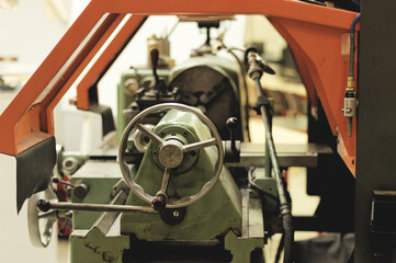 Detail of an old industrial conventionnal lathe, focused on handles for machining